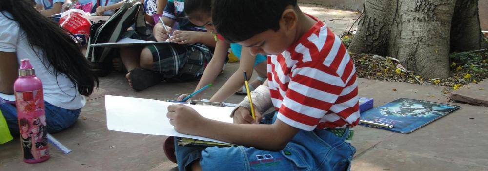 Child drawing outside