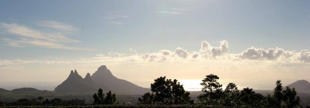 Landscape of Mauritius, showing mountains, oceans, and trees. 