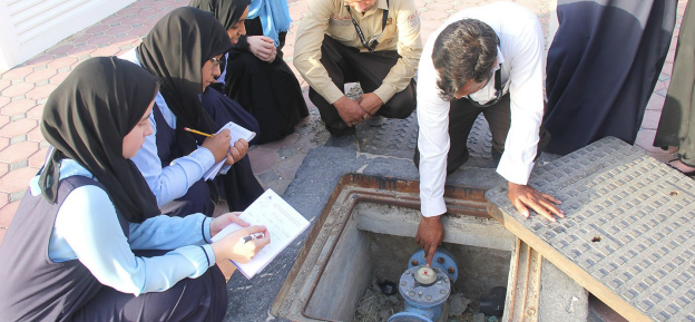 Students take notes on how a water pump works