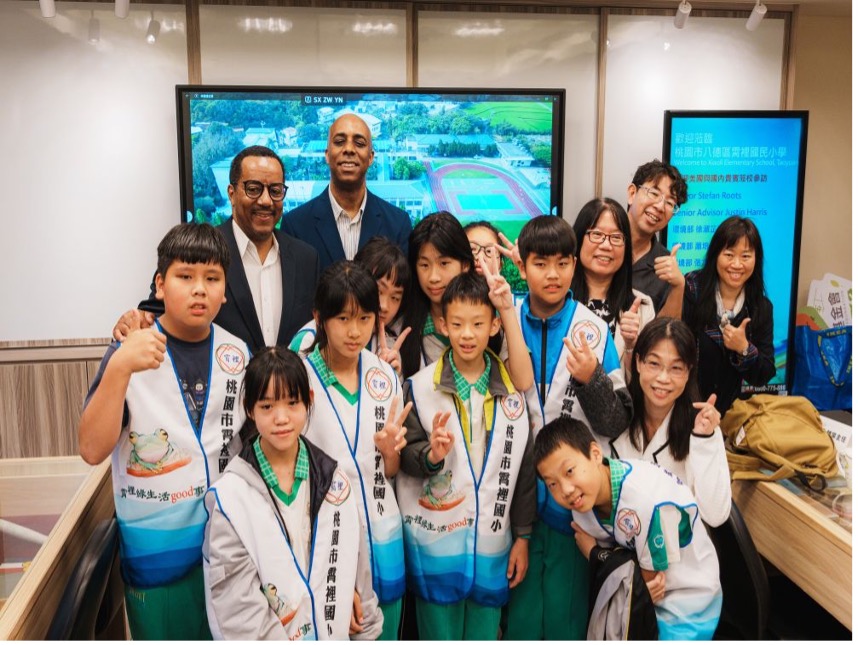 Mayor Roots and Justin Harris with Xioali Elementary School students.