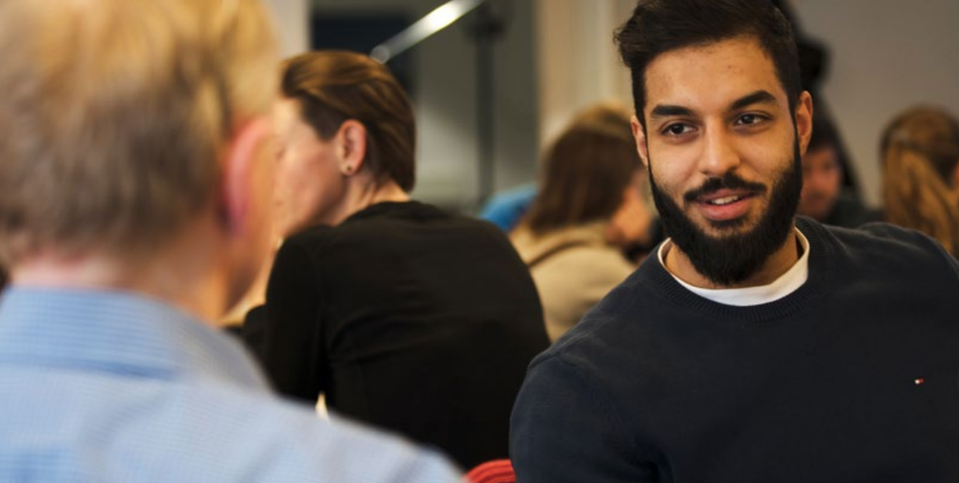 Man talking to others at a meeting