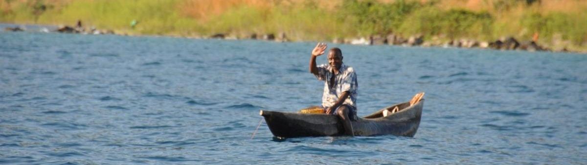 Image of a person waving in a canoe