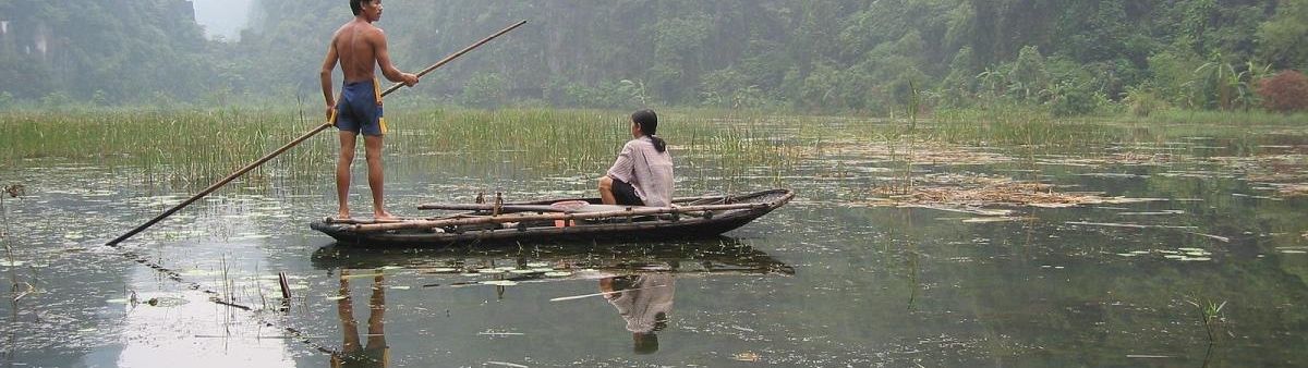 Image of people in a wooden canoe