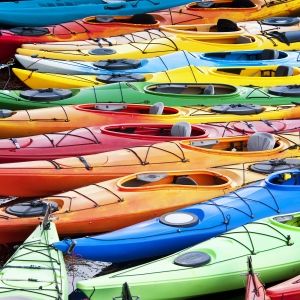 multicolored kayaks at shore