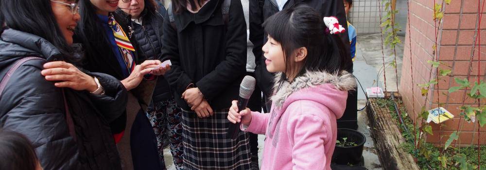 Young girl speaking to crowd